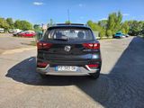 the back end of a black car parked in a parking lot