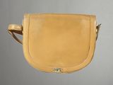 une photo d'un sac à main beige accroché à un mur