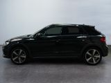 the black suv is parked in a large room with a white wall