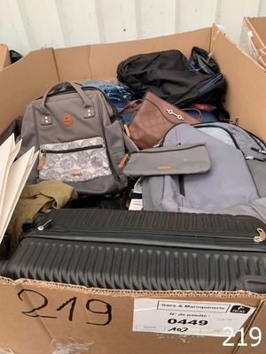 a box full of luggage sitting outside of a building