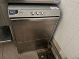 a silver oven sitting in the corner of a kitchen