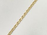 a close up of a gold chain bracelet on a white background