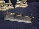 two antique brass candles and a mirror on the floor