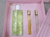 a pink box with a bottle of perfume and a bottle of perfume in it