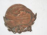 a metal plaque with a picture of a woman on it