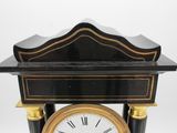 a black and gold clock with roman numerals on it