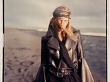 a polaroid photograph of a woman standing on the beach