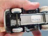 a person holding a toy car in their hand