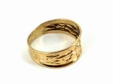 a close up of a gold ring on a white surface