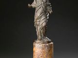 an image of a statue of a woman standing on top of a marble pedestal