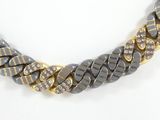 grey and gold chain necklace with large stones on a white surface