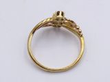 a close up of a gold ring on a white surface