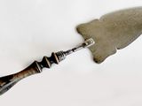 a knife with a handle on a white surface