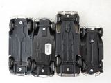 four black toy cars sitting on top of each other