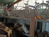 many bicycles that are sitting on the shelves in the garage