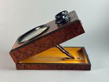 a wooden box with a pen in it on a table