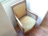 a chair that is next to a window in a room