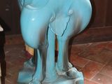 a blue vase that is on top of a table
