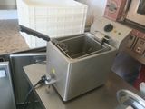a deep fryer sitting on a counter in a kitchen