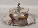 a silver plate with a flower on it and a saucer on it