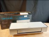 a white printer sitting on top of a table next to a box