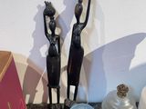 two figurines sitting on a table next to a box
