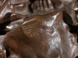 a close up of a bronze statue of a person holding hands