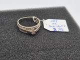 a close up of a ring with a price tag on a piece of cloth