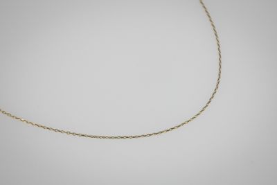 un collier à chaîne en or sur fond blanc