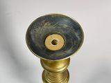 a gold candle holder on a white background