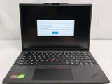 the laptop is open on a white surface with a keyboard and mouse