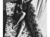 black and white photograph of a woman laying on a couch