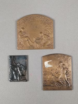 three plaques on the wall of a room