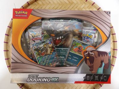a box of pokemon cards sitting on top of a basket