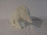 porcelain figurine of a polar bear sitting on a white surface