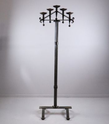 a tall metal pole with three candles on top of it