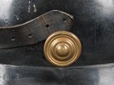 an old fashioned helmet with a metal buckle on the side of it