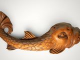 a wooden sculpture of a fish on the wall