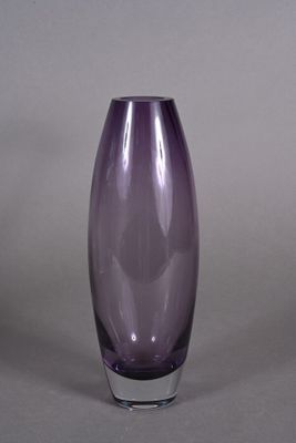 a purple glass vase that is sitting on a table