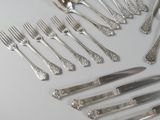 a lot of silver spoons and forks on the table