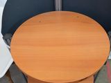 two chairs and a table in a room with a white wall