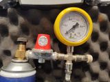 a close up of a gas can and a pressure gauge