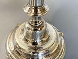 a silver vase that is sitting on a table