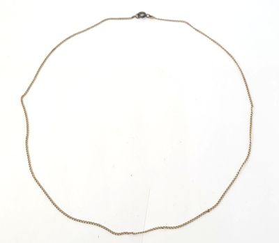 a close up of a necklace on a white surface with a white background