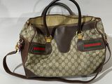 beige and brown guccissi handbag on white background