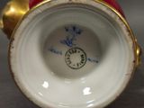 a close up view of a vase with a clock on it