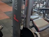 gym equipment in a gym with a red wall in the background