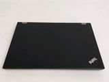 a laptop that is sitting on a white surface