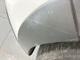 a close up of a car ' s front bumper and tire