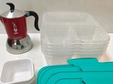 many containers and containers on the table with a coffee pot